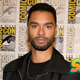 Regé-Jean Page in front of a Comic-Con standee